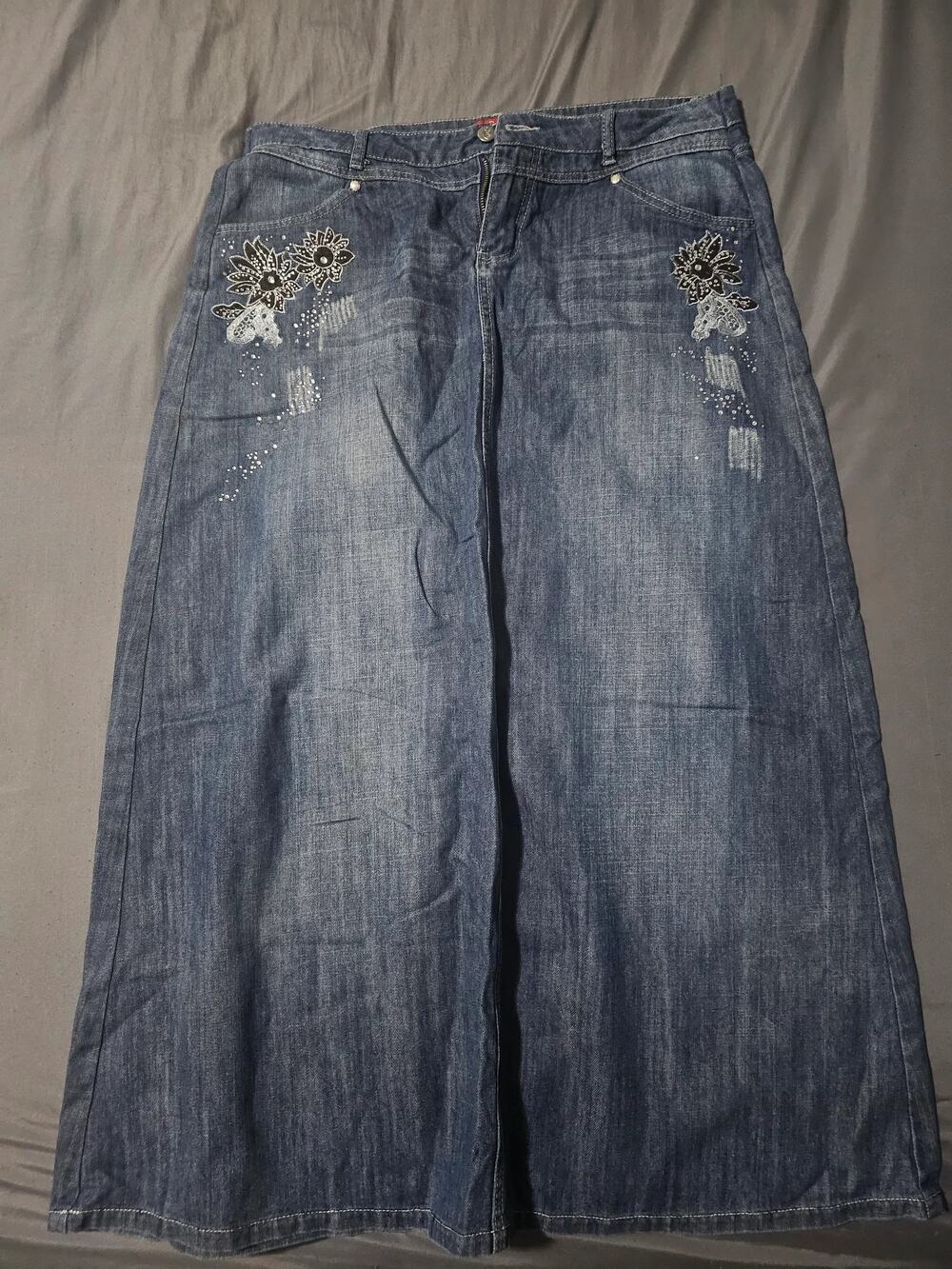 Dark wash denim jeans with contrast stitching and hem seam detail